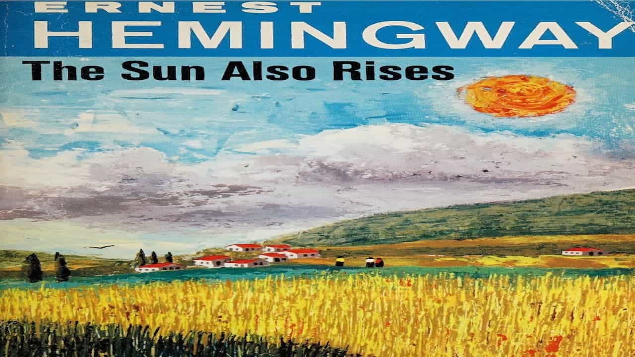 Book cover of Ernest Hemingway's "The Sun Also Rises" featuring painted landscape with wheat field and village
