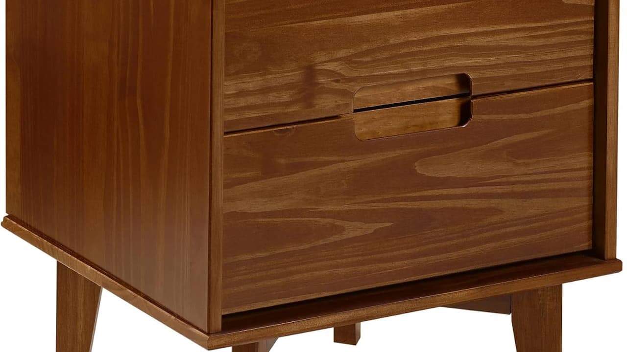  Close-up of wooden chest of drawers or dresser with natural wood grain finish and multiple drawer fronts