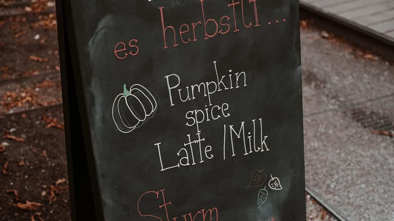 A small rectangular chalkboard sign on a stand, typically used for labeling or decoration