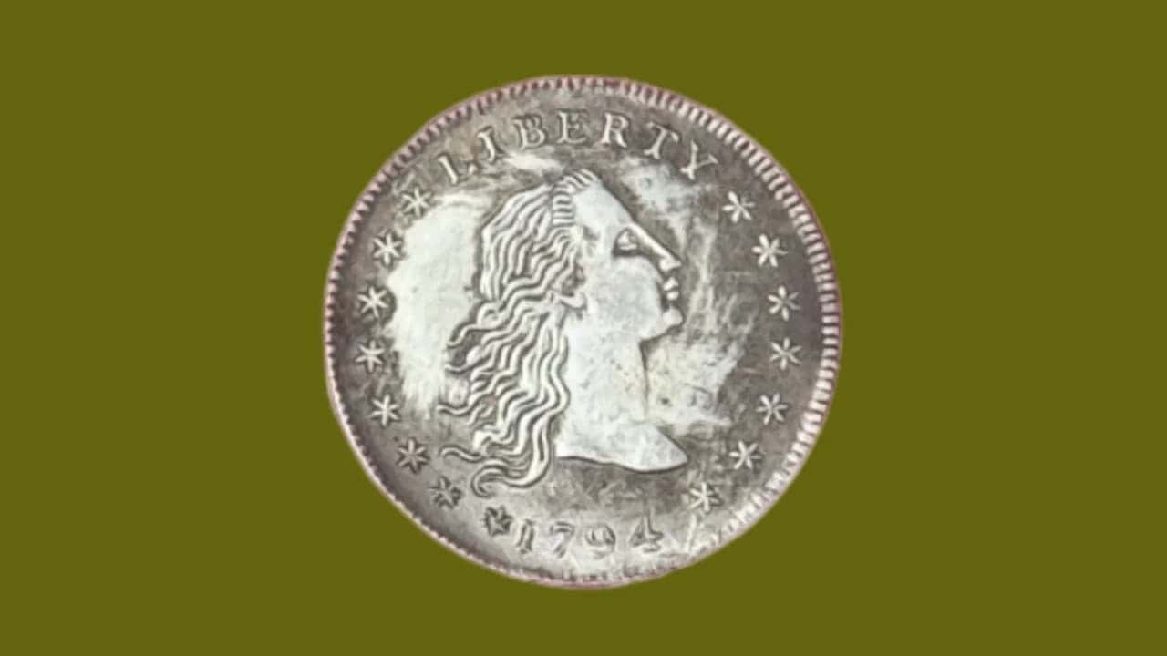  A 1794 silver coin showing Lady Liberty with flowing hair, surrounded by stars and the word "LIBERTY" above