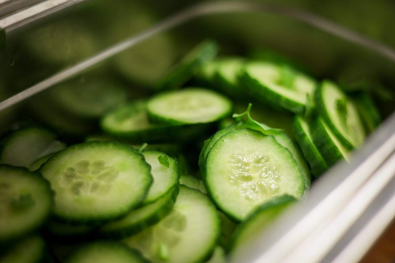 Close-up of Sliced Cucumbers in a Steel Container