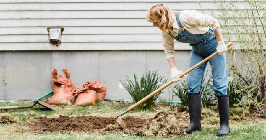 Woman Wearing Denim Overalls and Wellies Gardening