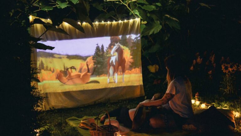 A Couple Watching a Movie at a Picnic Date
