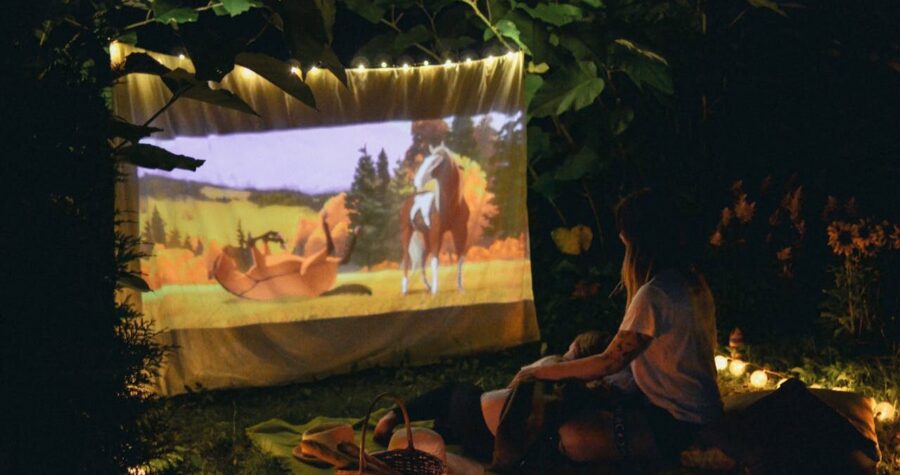 A Couple Watching a Movie at a Picnic Date