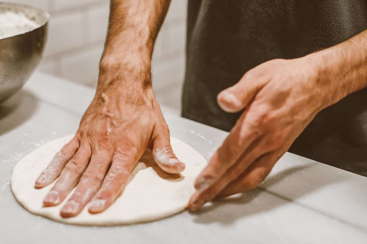 Close-up of a Pizzerman Making a Pizza Dough
