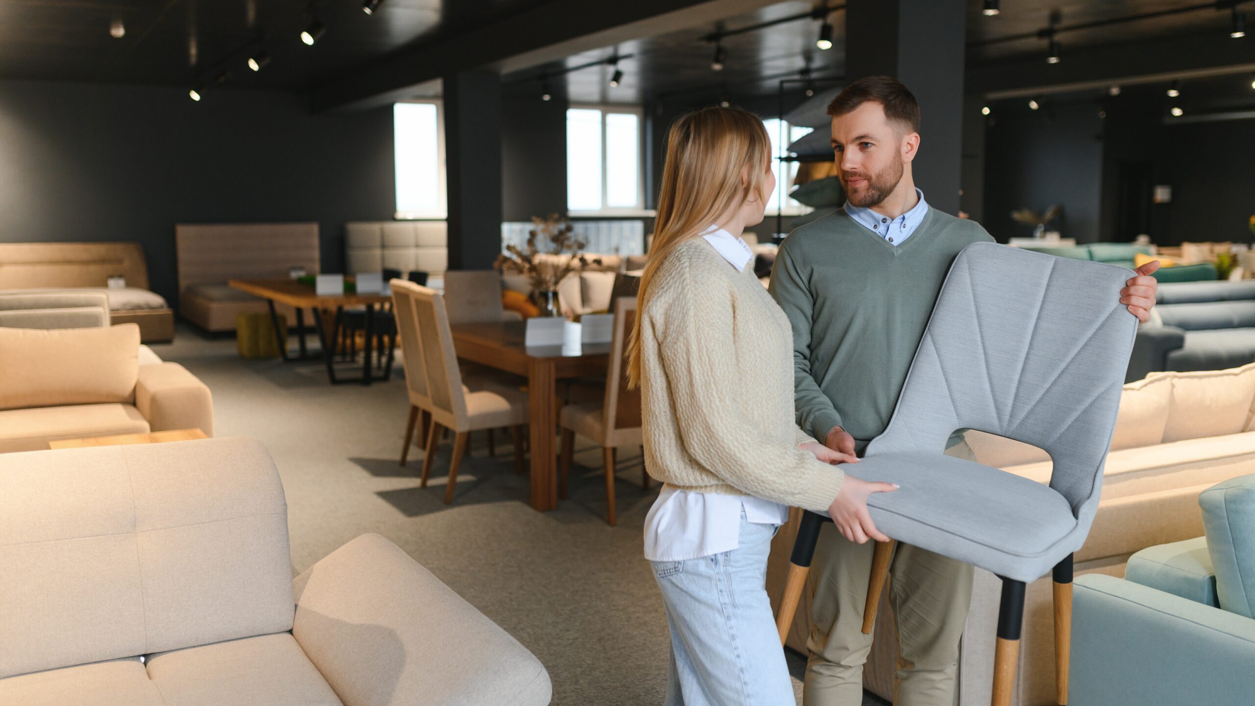 Attractive woman with her husband at the furniture store showroom.