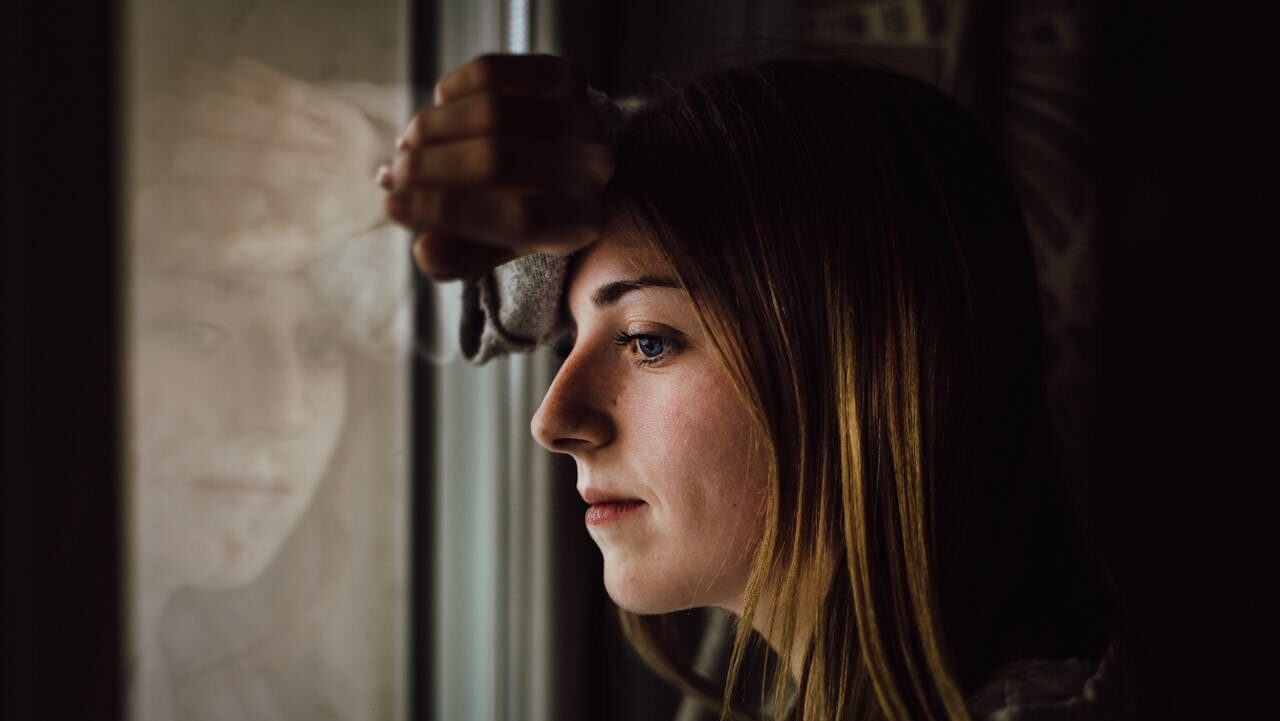 Woman Leaning on Glass Window