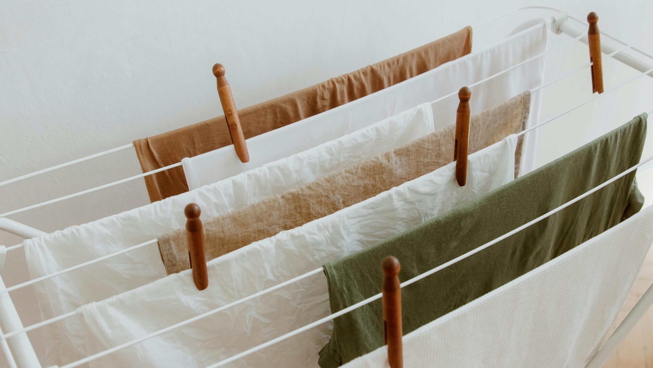 clothes is being hanged on the drying rack