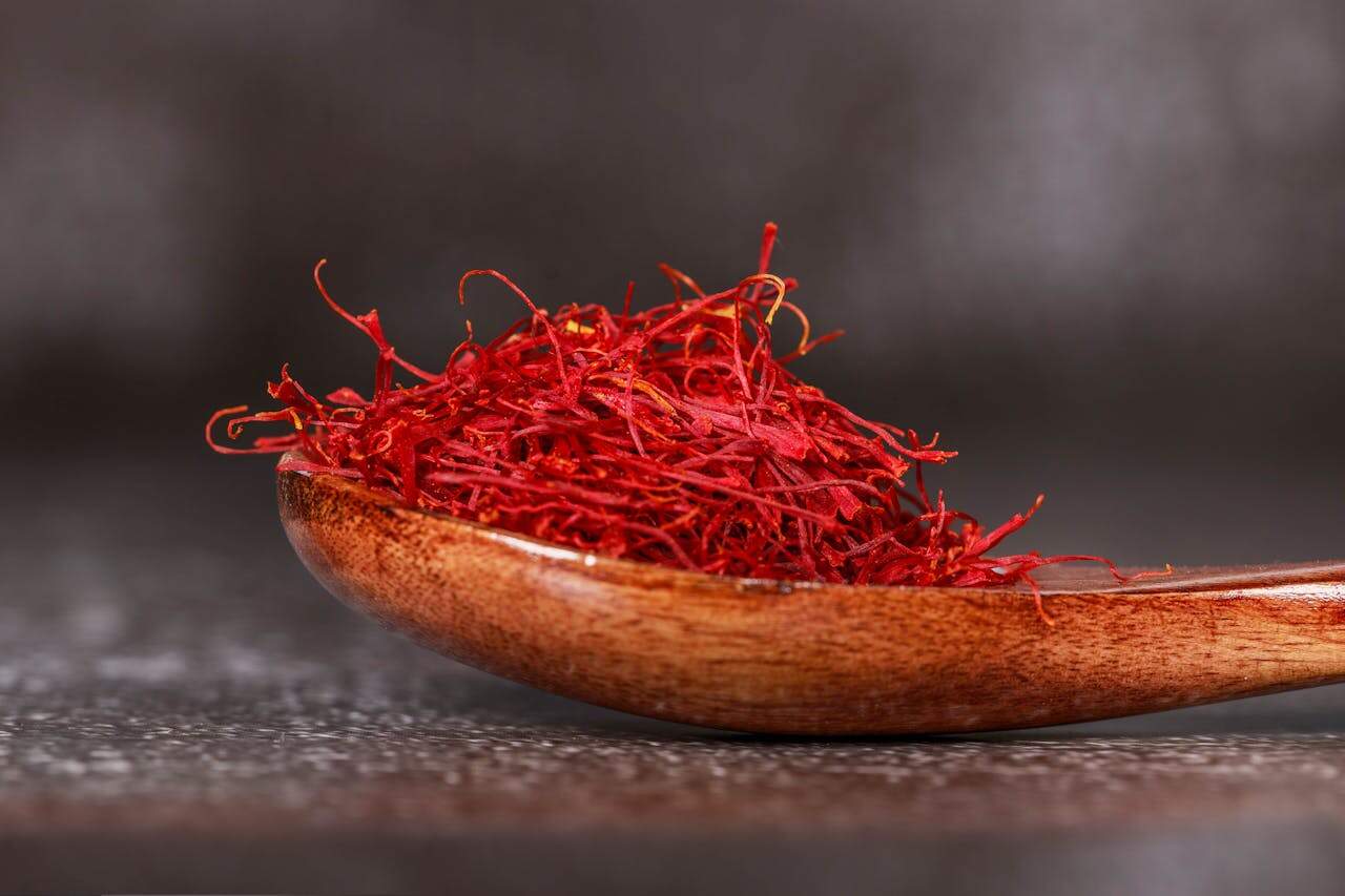 Red Saffron Spice on Brown Wooden Spoon