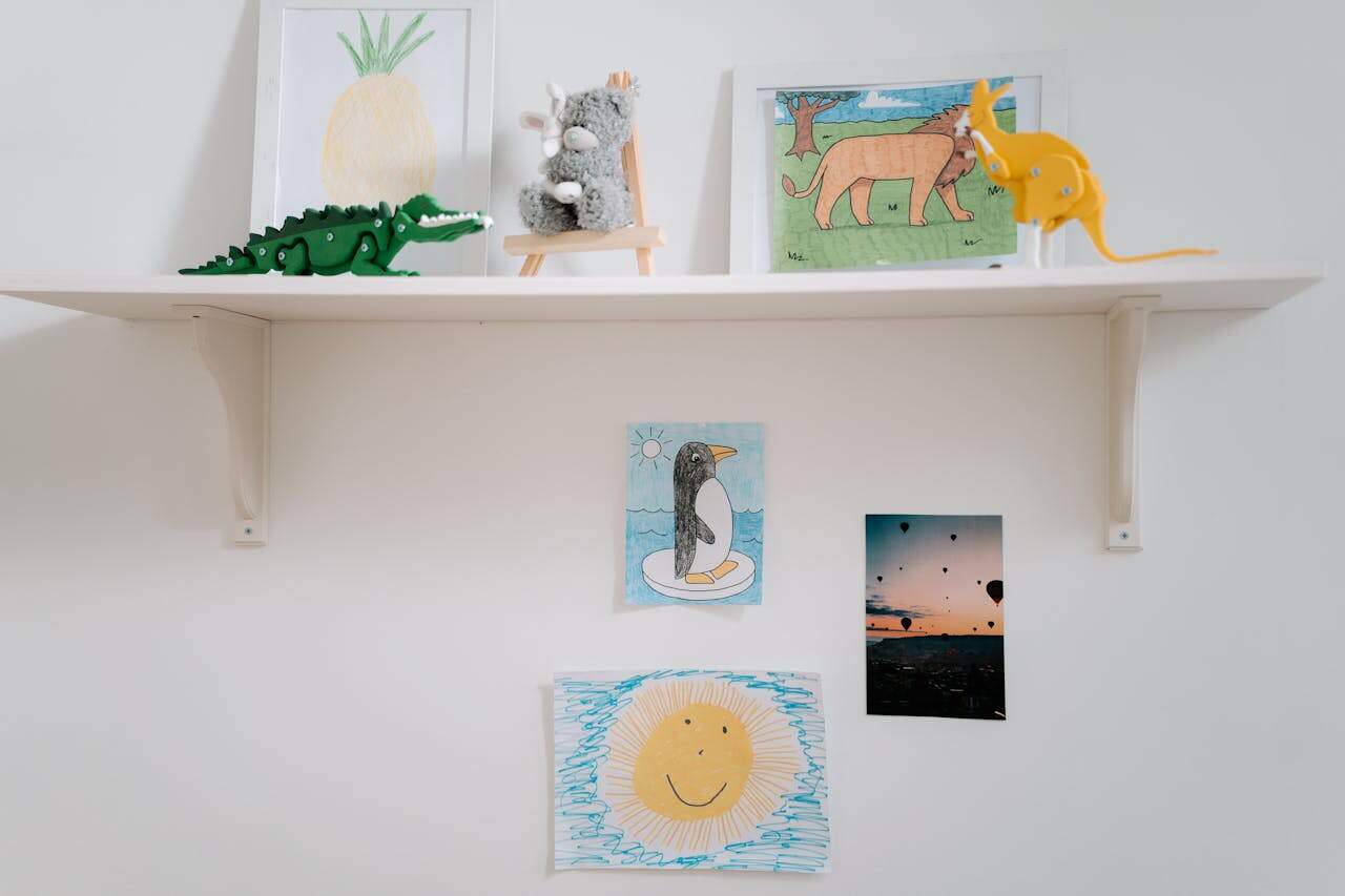 White Wooden Shelf With Kids Artworks