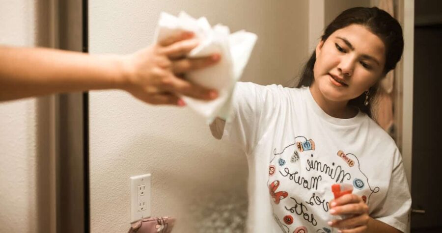 Close-Up Shot of a Woman Wiping the Mirror