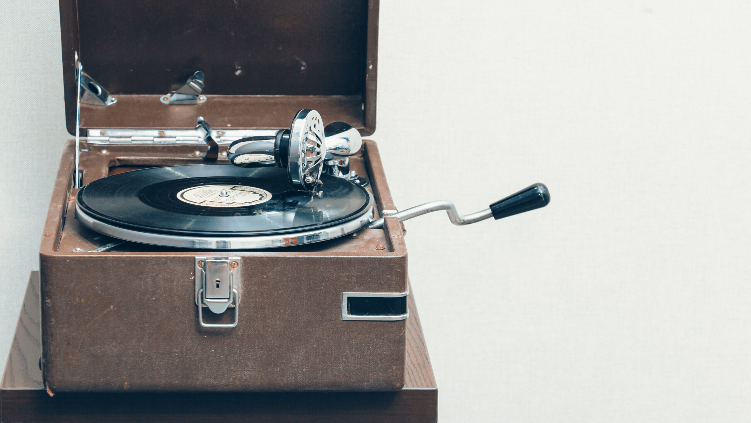 Old retro portable gramophone isolated, vintage style toned, with empty space